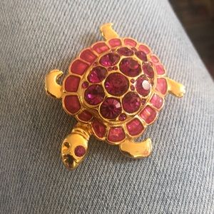Costume jewelry turtle brooch with pink stones.